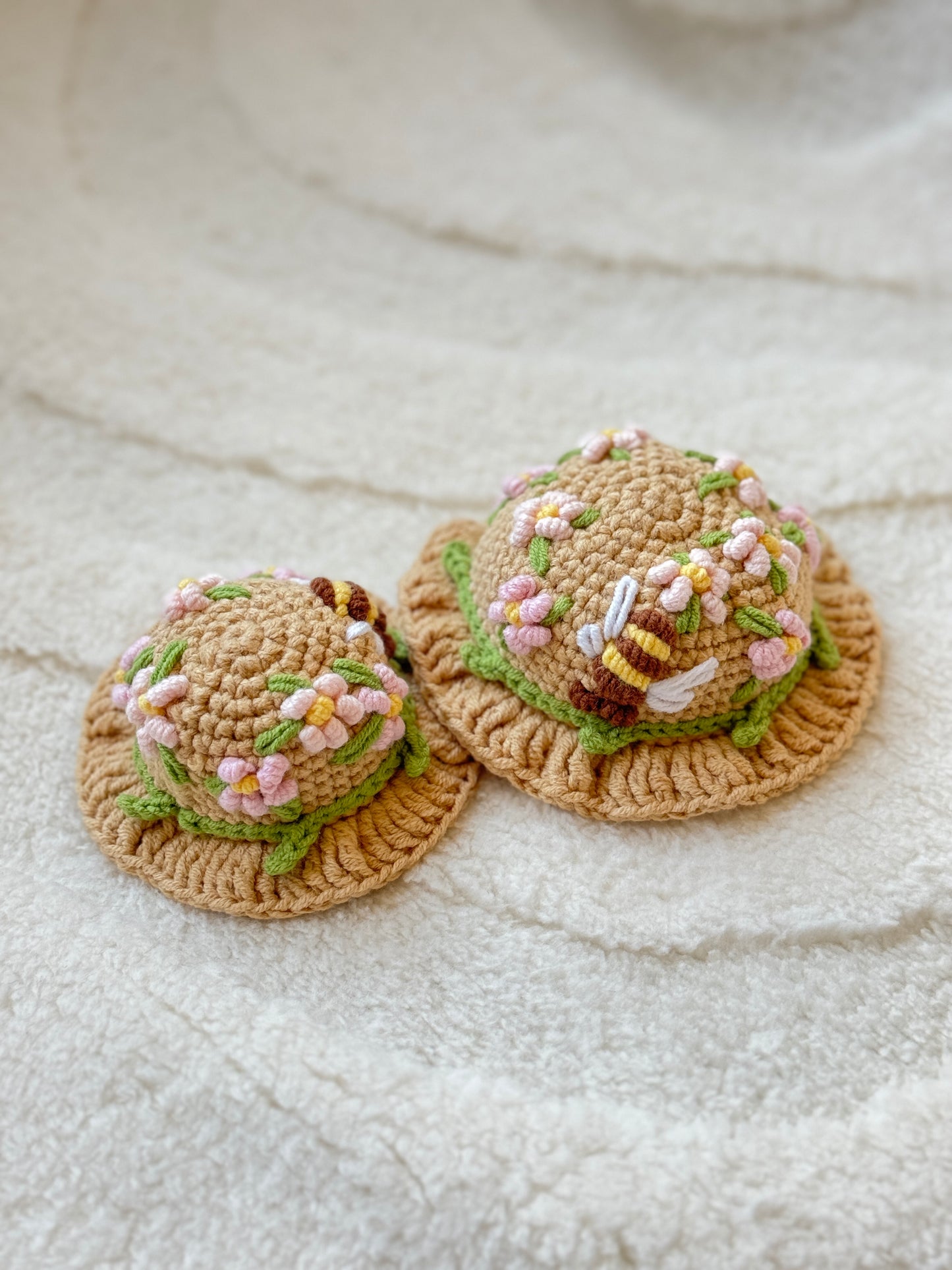 Two floral hats on the blanket