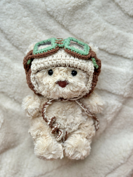 Jellycat Bart Junior plush styled in cozy crochet green pilot hats with soft neutral aesthetic background.