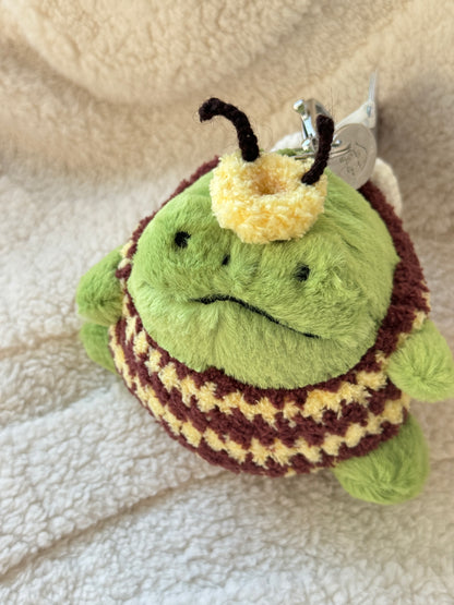 Cute Jellycat Ricky Rain Frog dressed as a bumble bee with crochet striped costume and miniature bee wings.
