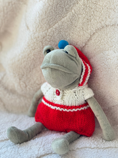 Side view of hand-knitted hooded onesie with pom pom on Jellycat Fergus Frog plush