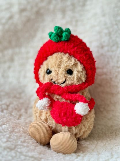 Jellycat Peanut in full red crochet tomato outfit with white pompom scarf, front-facing display on fluffy white surface by Z Creations